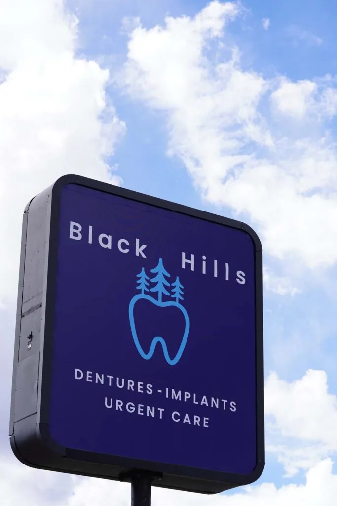 Black Hills Dentures & Implants Care Sign